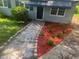 Landscaped front yard with red mulch, white gravel, and stone edging around flower beds at 2436 Clarissa Nw Dr, Atlanta, GA 30318