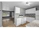 Open kitchen showcasing white cabinets, modern appliances, and a view into the living area at 2436 Clarissa Nw Dr, Atlanta, GA 30318