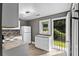 Efficient kitchen layout with white appliances and access to the backyard through a security door at 2436 Clarissa Nw Dr, Atlanta, GA 30318