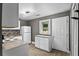Compact kitchen with white cabinets, stylish backsplash, and modern lighting fixture at 2436 Clarissa Nw Dr, Atlanta, GA 30318