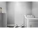 Cozy laundry area with washer and vintage water heater situated in a convenient location at 2436 Clarissa Nw Dr, Atlanta, GA 30318