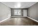 Bright and airy living room with laminate wood flooring and a large window at 2436 Clarissa Nw Dr, Atlanta, GA 30318