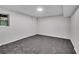 Basement bedroom featuring neutral carpet, window with natural light, and clean white walls for a peaceful retreat at 6881 Hickory Hollow Dr, Douglasville, GA 30135