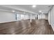 Large basement featuring wood flooring, white walls and support columns, recessed lights, and natural light at 6881 Hickory Hollow Dr, Douglasville, GA 30135