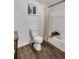 Bathroom with a wooden accent shelf over the bathtub and wood look floors at 6881 Hickory Hollow Dr, Douglasville, GA 30135