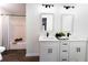 Bright bathroom featuring a double vanity with modern fixtures and a shower-tub combo at 6881 Hickory Hollow Dr, Douglasville, GA 30135