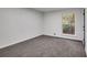 Bedroom with a light grey carpet, freshly painted walls, and bright natural light, creating a fresh and inviting space at 6881 Hickory Hollow Dr, Douglasville, GA 30135