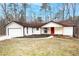 Charming single-story home with a bright red front door and attached two car garage at 6881 Hickory Hollow Dr, Douglasville, GA 30135