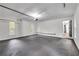 A clean and well-lit two car garage offering ample storage space, painted white walls, and convenient interior access at 6881 Hickory Hollow Dr, Douglasville, GA 30135
