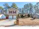 Beige house with red shutters, two-car garage, and a landscaped yard at 3100 Aberdeen Way, Lithonia, GA 30038