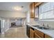 Kitchen featuring wood cabinets, double sink, and a view of the living area at 3100 Aberdeen Way, Lithonia, GA 30038