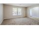 Living room with neutral walls, carpeted floors, and two windows at 3100 Aberdeen Way, Lithonia, GA 30038