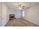 Living room with brick fireplace, ceiling fan, and carpet at 3100 Aberdeen Way, Lithonia, GA 30038