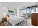 Bright bedroom with a modern design, hardwood floors, and a large window showcasing city views at 3325 Piedmont Ne Rd # 1708, Atlanta, GA 30305