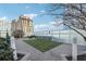 Rooftop dog park with artificial grass, shade tree, and privacy fence for resident use at 3325 Piedmont Ne Rd # 1708, Atlanta, GA 30305
