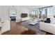 Bright living room with hardwood floors, city views, and comfortable modern furniture at 3325 Piedmont Ne Rd # 1708, Atlanta, GA 30305