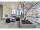 Relax on the stylish outdoor patio featuring comfortable seating, a stone fireplace, and city views at 3325 Piedmont Ne Rd # 1708, Atlanta, GA 30305