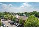 Scenic view of city buildings and lush trees with multiple cars in parking spaces at 304 Woodstock Seven Dr, Woodstock, GA 30188