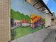 Exterior view of wall with a colorful mural depicting downtown Woodstock and railway train at 304 Woodstock Seven Dr, Woodstock, GA 30188