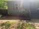 Gray home with window and door, surrounded by flower bed and patchy grass at 501 Aberdeen Nw Dr, Atlanta, GA 30318