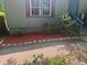 Close up of front yard with gray siding, red mulch, and small bushes at 501 Aberdeen Nw Dr, Atlanta, GA 30318