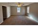 Spacious bedroom with carpet, ceiling fan, and large window at 5090 Great Meadows Rd, Lithonia, GA 30038