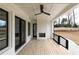 Covered back porch with wood decking, fireplace, and ceiling fan at 816 Hillwood Dr, Marietta, GA 30068