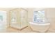 Luxurious bathroom with a marble shower, soaking tub, and modern fixtures at 816 Hillwood Dr, Marietta, GA 30068