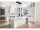 Modern kitchen with large island, white cabinets, and high-end appliances at 816 Hillwood Dr, Marietta, GA 30068