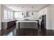 Modern kitchen with dark gray island, white cabinets, and stainless steel appliances at 816 Hillwood Dr, Marietta, GA 30068