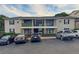 Apartment building with balconies, stone accents, and ample parking space for residents and visitors at 1150 Collier Nw Rd # 4B, Atlanta, GA 30318