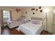 Bright bedroom with two beds, hardwood floors, a window, and wall decorations at 1150 Collier Nw Rd # 4B, Atlanta, GA 30318