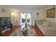 Well-lit living room with hardwood floors, neutral-toned furniture, and a sliding door to outside at 1150 Collier Nw Rd # 4B, Atlanta, GA 30318