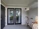 Private patio with black-framed glass doors, offering peaceful outdoor space and natural light at 1150 Collier Nw Rd # 4B, Atlanta, GA 30318