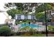Scenic view of the community pool, surrounded by mature trees and well-manicured grounds at 1150 Collier Nw Rd # 4B, Atlanta, GA 30318