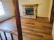 Living room with stone fireplace and wood-look flooring at 1593 Cherry Hill Ln, Conyers, GA 30094