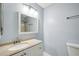 Bathroom featuring a white vanity with a large mirror, complemented by modern lighting fixtures at 511 Barrington Hills Dr, Atlanta, GA 30350