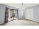 Spacious bedroom features a sliding glass door to private patio, plush carpeting, and natural light at 511 Barrington Hills Dr, Atlanta, GA 30350