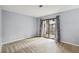 Bedroom features a sliding glass door to private patio and plush carpeting at 511 Barrington Hills Dr, Atlanta, GA 30350