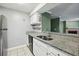 This kitchen shows granite countertops, a stainless steel refrigerator and white cabinetry at 511 Barrington Hills Dr, Atlanta, GA 30350