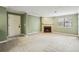 Spacious living room features neutral carpet, fresh paint, and a cozy fireplace at 511 Barrington Hills Dr, Atlanta, GA 30350