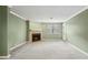 Comfortable living room with neutral carpet, fresh paint, and a cozy fireplace at 511 Barrington Hills Dr, Atlanta, GA 30350
