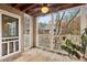 Screened porch features ceiling fan and wooded views for outdoor enjoyment at 511 Barrington Hills Dr, Atlanta, GA 30350