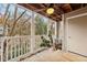 Covered porch with ceiling fan and wooded views provides a relaxing outdoor space at 511 Barrington Hills Dr, Atlanta, GA 30350