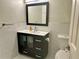 Bathroom with dark vanity, toilet and white tile at 795 Hammond Dr # 401, Atlanta, GA 30328