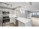 Modern kitchen with white cabinets, stainless steel appliances and breakfast bar at 795 Hammond Dr # 401, Atlanta, GA 30328