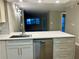 Modern kitchen with breakfast bar and view to living room at 795 Hammond Dr # 401, Atlanta, GA 30328