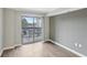 Bright living room with balcony access and hardwood floors at 795 Hammond Dr # 401, Atlanta, GA 30328