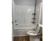 Bright bathroom features a tub-shower with a sleek, organized storage rack at 2467 Shady Grove Rd, Carrollton, GA 30116
