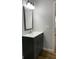 Bathroom vanity featuring a modern light fixture, gray cabinet, and sleek countertop at 2467 Shady Grove Rd, Carrollton, GA 30116